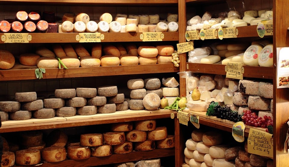 Pecorino Romano on the shelves in an Italian cheese boutique